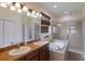 Bright bathroom with a jacuzzi tub, walk-in shower, double sinks, and large vanity mirror at 4119 101St E Ave, Parrish, FL 34219