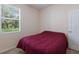Bedroom with a window overlooking greenery, a comfortable bed, and white door at 4119 101St E Ave, Parrish, FL 34219