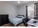Functional bedroom with a desk, neutral walls, and a comfortable bed at 4119 101St E Ave, Parrish, FL 34219