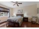 Bedroom featuring a large bed with a decorative headboard, lamps, and side tables at 4119 101St E Ave, Parrish, FL 34219