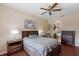 Well-lit bedroom with ceiling fan and a door leading to a bathroom with tub and shower at 4119 101St E Ave, Parrish, FL 34219