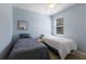 Comfortable bedroom with blue walls, two twin beds, and a window at 4119 101St E Ave, Parrish, FL 34219