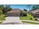 Charming single-story home with a well-manicured lawn and a convenient three-car garage at 4119 101St E Ave, Parrish, FL 34219