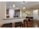 Kitchen and dining area with stainless steel appliances, hanging lights, and breakfast bar at 4119 101St E Ave, Parrish, FL 34219