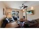 Comfortable living room with ceiling fan, leather furniture, and view of the outdoor patio at 4119 101St E Ave, Parrish, FL 34219