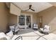 Relaxing covered patio with ceiling fan and comfortable seating near sliding glass doors at 4119 101St E Ave, Parrish, FL 34219