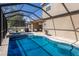 Backyard pool and spa featuring a screened-in enclosure, perfect for year-round enjoyment at 4119 101St E Ave, Parrish, FL 34219