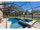 Inviting pool and spa surrounded by screened enclosure with ample space for outdoor enjoyment at 4119 101St E Ave, Parrish, FL 34219