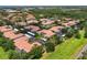 Aerial view of the condominium community featuring multiple residential buildings with lush green surroundings at 4244 Central Sarasota Pkwy # 726, Sarasota, FL 34238