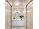 Bright, clean bathroom with white cabinets, a round mirror, and modern lighting at 4244 Central Sarasota Pkwy # 726, Sarasota, FL 34238