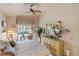 Relaxing bedroom showcasing a dresser, mirror, balcony view, and ample natural lighting at 4244 Central Sarasota Pkwy # 726, Sarasota, FL 34238