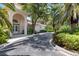 Well maintained building exterior with manicured landscaping and mature trees at 4244 Central Sarasota Pkwy # 726, Sarasota, FL 34238