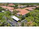 Exterior view of multi-Gathering condominiums with tile roofs, well-maintained landscaping, and covered parking at 4244 Central Sarasota Pkwy # 726, Sarasota, FL 34238