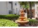 Beautiful water fountain with manicured landscaping and a stairway to the units at 4244 Central Sarasota Pkwy # 726, Sarasota, FL 34238