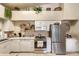 Bright eat-in kitchen with stainless steel appliances, granite countertops, and white cabinetry at 4244 Central Sarasota Pkwy # 726, Sarasota, FL 34238