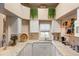 Bright and airy kitchen featuring white cabinets, granite countertops, a decorative backsplash, and ample natural light at 4244 Central Sarasota Pkwy # 726, Sarasota, FL 34238