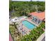 Aerial view of the community pool with lounge chairs, tables and beautiful green landscaping at 4244 Central Sarasota Pkwy # 726, Sarasota, FL 34238