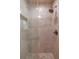 Modern walk-in shower featuring neutral tile, a rain shower head, and a convenient shampoo niche at 4244 Central Sarasota Pkwy # 726, Sarasota, FL 34238