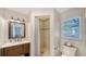 Bathroom featuring tiled shower, vanity with sink and mirror, and a toilet at 4514 Trails Dr, Sarasota, FL 34232