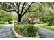 The Lakes Estates neighborhood sign featuring mature trees and landscaping at 4514 Trails Dr, Sarasota, FL 34232