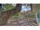 Deck with white rails featuring mature trees and home in background at 4514 Trails Dr, Sarasota, FL 34232