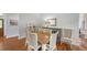Dining area with wooden floors, stylish chairs, decorative mirror, and elegant lighting at 4514 Trails Dr, Sarasota, FL 34232