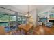 Open dining area with lake views, sliding glass doors to the deck, and adjacent living room at 4514 Trails Dr, Sarasota, FL 34232