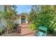 Beautiful blue double front doors with covered entryway and tropical landscaping at 4514 Trails Dr, Sarasota, FL 34232