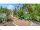 Inviting outdoor sitting area with lush landscaping and wooden steps to the front door at 4514 Trails Dr, Sarasota, FL 34232