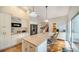 Spacious kitchen with island and seating, white cabinets, granite countertops, and stainless steel appliances at 4514 Trails Dr, Sarasota, FL 34232