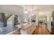 Modern kitchen with large island, stainless appliances, and glass doors opening to a patio with trees at 4514 Trails Dr, Sarasota, FL 34232