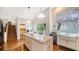 Bright kitchen with a large island, stainless steel appliances, and a view to the outdoor deck at 4514 Trails Dr, Sarasota, FL 34232