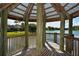 Covered gazebo overlooking a picturesque lake, providing a serene and shaded retreat at 4514 Trails Dr, Sarasota, FL 34232