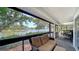 Relaxing screened lanai with water view, comfortable seating and space for dining at 4514 Trails Dr, Sarasota, FL 34232