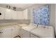 Well-equipped laundry room with modern washer, dryer, sink, and ample storage at 4514 Trails Dr, Sarasota, FL 34232