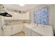 Functional laundry room with washer, dryer, sink, counter and storage cabinets at 4514 Trails Dr, Sarasota, FL 34232