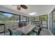 Enclosed patio featuring a lake view, ceiling fan, skylight and ample seating at 4514 Trails Dr, Sarasota, FL 34232