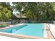 Sparkling swimming pool with a shallow end and well-maintained surroundings and trees at 4514 Trails Dr, Sarasota, FL 34232