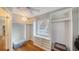 Walk-in closet with custom shelving and storage, bright natural light, and hardwood floors at 4514 Trails Dr, Sarasota, FL 34232