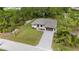 Aerial view of the landscaped home, driveway and front lawn at 4661 Forlano Cir, North Port, FL 34291
