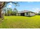 Lush backyard with sprawling lawn and mature trees extending along the edge of the property at 4661 Forlano Cir, North Port, FL 34291