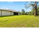 Expansive backyard featuring lush green lawn and mature trees extending to the property line at 4661 Forlano Cir, North Port, FL 34291