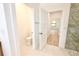 Bathroom featuring a tiled walk-in shower, toilet, and a doorway leading to a bedroom at 4661 Forlano Cir, North Port, FL 34291