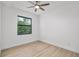 Light filled bedroom with hardwood flooring, ceiling fan, and scenic backyard view at 4661 Forlano Cir, North Port, FL 34291