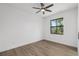 Bright bedroom with hardwood flooring, ceiling fan, and window views of the outside at 4661 Forlano Cir, North Port, FL 34291