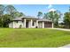 Charming one-story home boasts a contemporary design with a large lawn and modern driveway at 4661 Forlano Cir, North Port, FL 34291