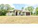 Single-story home featuring a neutral color scheme, a wide lawn, and a two-car garage at 4661 Forlano Cir, North Port, FL 34291