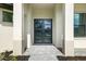 Modern home featuring a dark-framed glass front door with stone paver entry at 4661 Forlano Cir, North Port, FL 34291
