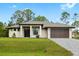 Beautiful single-story home featuring a modern architectural style, a two-car garage and a well manicured lawn at 4661 Forlano Cir, North Port, FL 34291