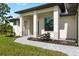 Home featuring a covered entry with elegant columns and manicured garden bed at 4661 Forlano Cir, North Port, FL 34291